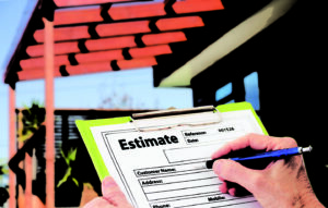Hand writing an estimate for home building renovation | two rivers roofing, inc