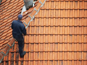 Roofer doing roof maintenance | two rivers roofing, inc Roofer Doing Roof Maintenance